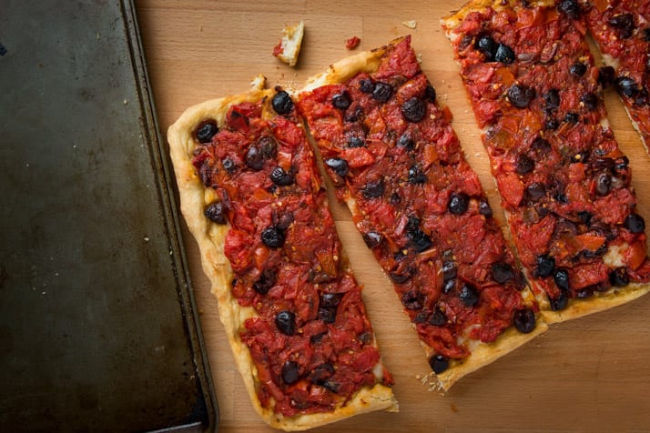 Nonnas Calabrese pizza recipe with tomatoes, kalamata olives, anchovies and hot peppers.
